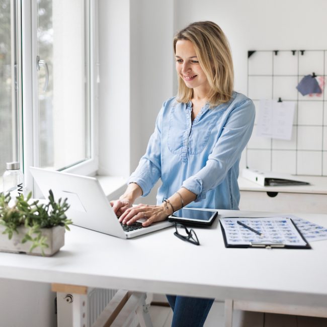 Businesswoman working at a standing desk in office